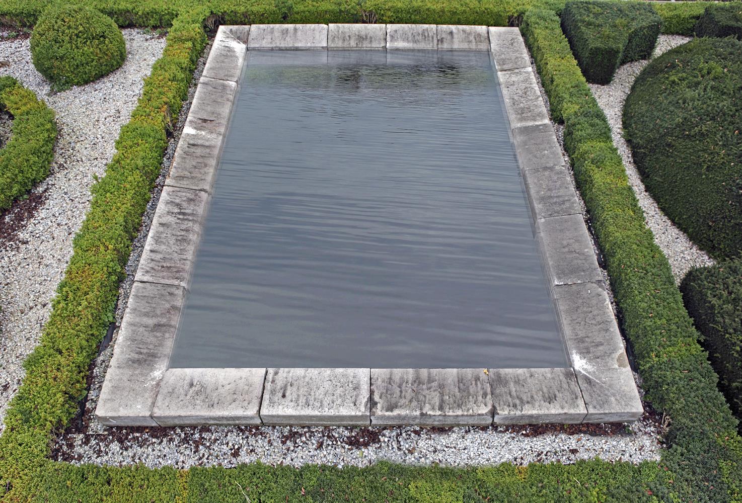 An ashlar cut Bourgogne stone rectangular pool surround
