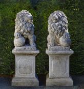 A pair of sculpted limestone models of lions on pedestals
