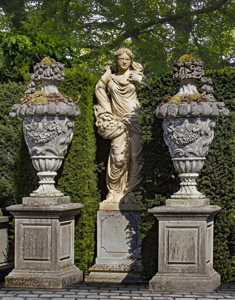 A pair of monumental carved limestone urns-and-covers, in Louis XVI taste