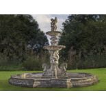 An elaborate and impressive stone composition two-tier garden fountain