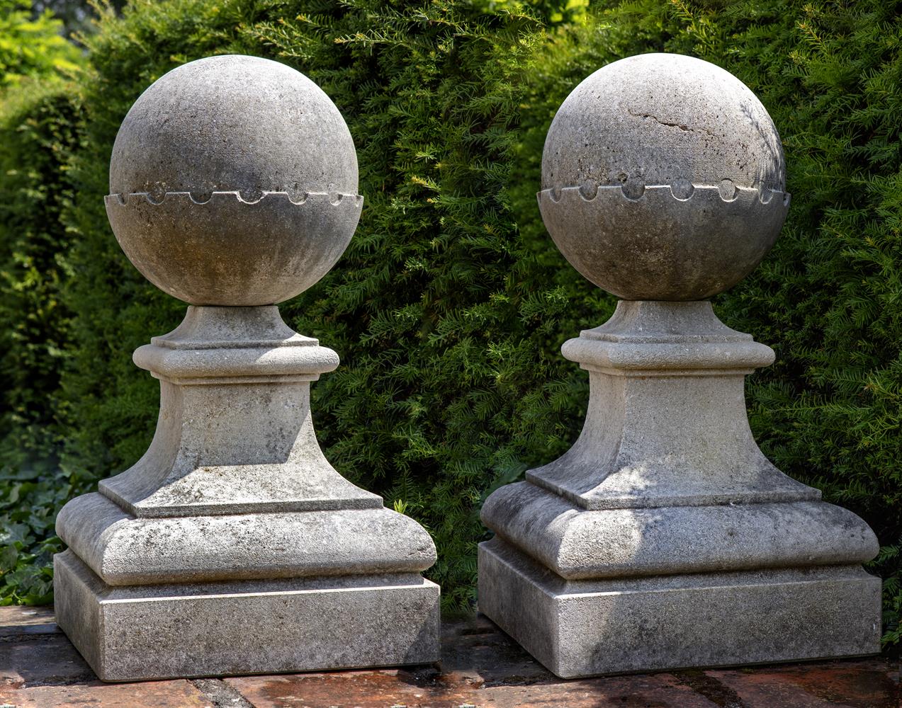 A pair of carved limestone pier finials