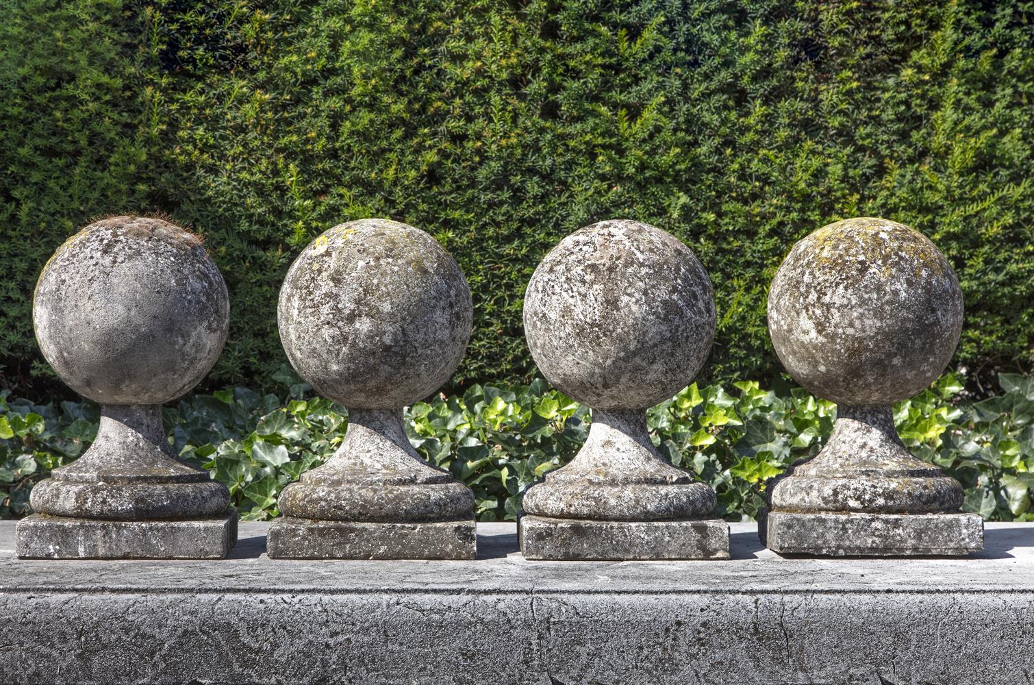 A set of four carved limestone pier finials