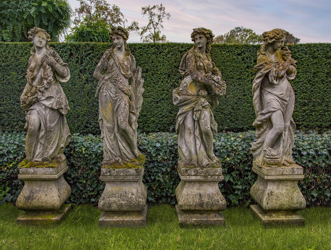 A set of four Continental sculpted limestone models of maidens representative of the Four Seasons
