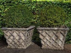 A pair of stone composition planters modelled as baskets