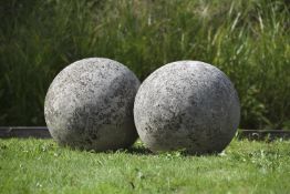 A pair of large limestone ornamental spheres