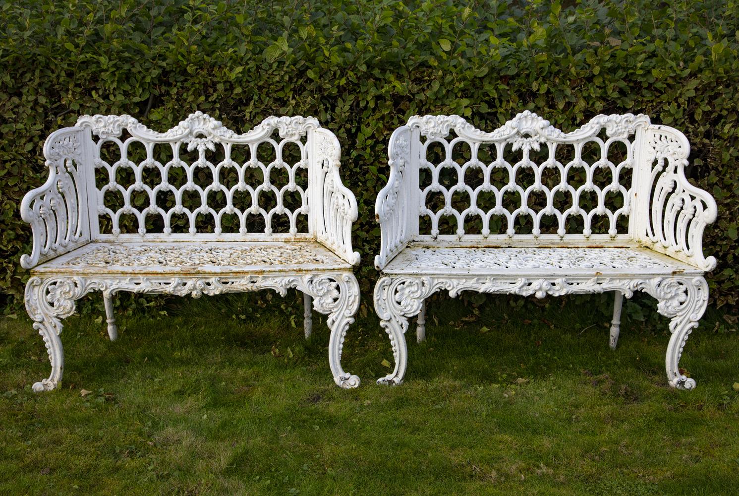 A pair of white painted cast iron garden seats