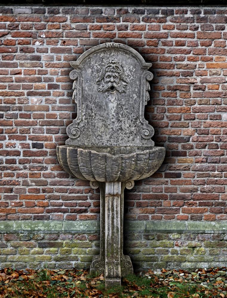 A Continental sculpted limestone wall fountain