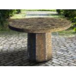 A carved stone garden table