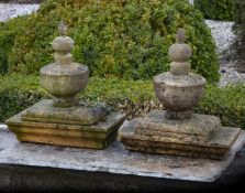 A pair of French carved sandstone pier finials