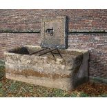 A wall fountain and trough