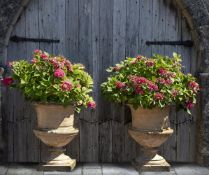 A pair of composition stone garden urns