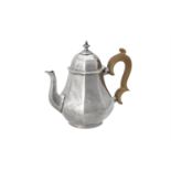 A silver octagonal baluster tea pot by R. & S. Garrard & Co.