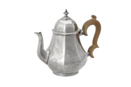 A silver octagonal baluster tea pot by R. & S. Garrard & Co.