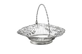 A late George II silver shaped oval swing handled bread basket by William Plummer