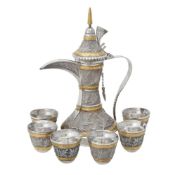 An Omani silver coloured and gilt coffee pot and six cups