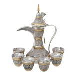 An Omani silver coloured and gilt coffee pot and six cups