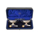 A cased pair of Victorian silver oval pedestal salts by Charles Stuart Harris