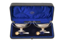 A cased pair of Victorian silver oval pedestal salts by Charles Stuart Harris