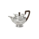 A Dutch silver half fluted circular tea pot