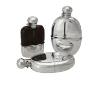 An Edwardian silver oval spirit flask by Army & Navy Cooperative Society Ltd.