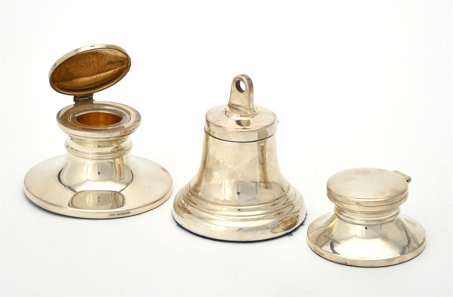 A silver bell shaped capstan inkwell