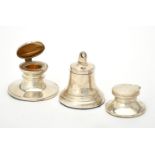 A silver bell shaped capstan inkwell