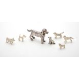 A collection of silver and silver coloured models of dogs