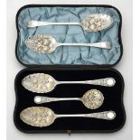 A cased pair of Victorian silver berry spoons and a sifting spoon by William Hutton & Sons Ltd.