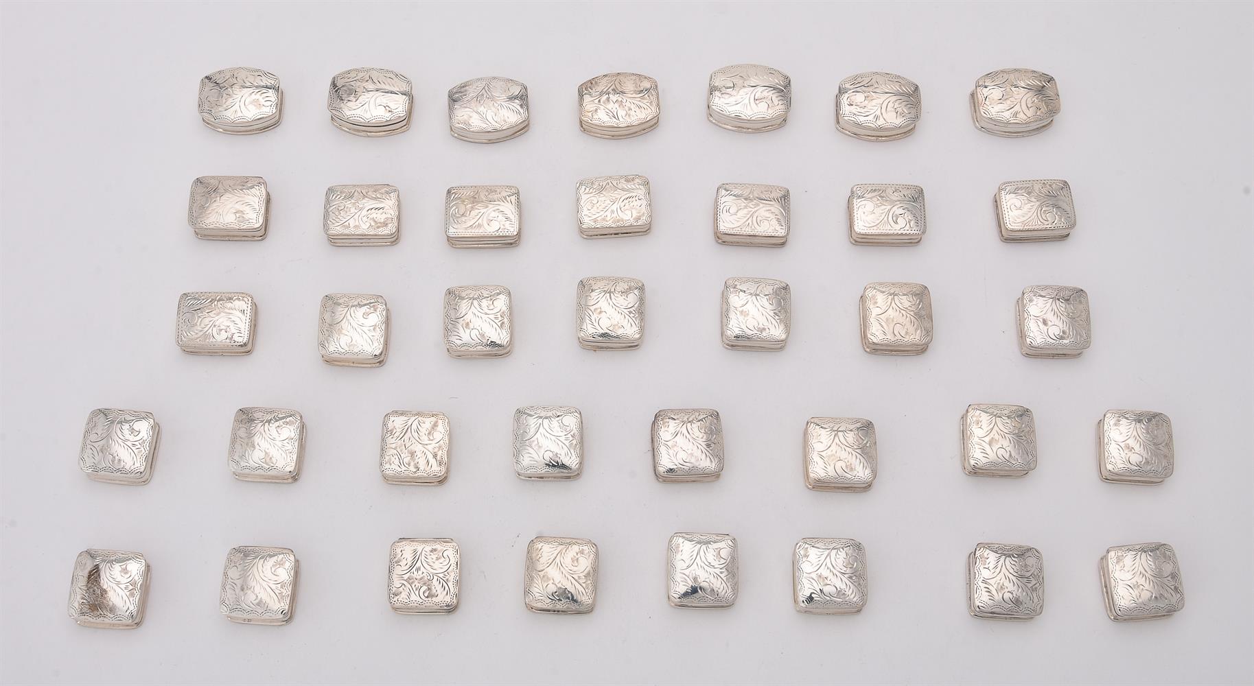 A collection of silver pill boxes