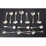 A collection of silver sauce ladles