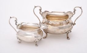 A silver oblong baluster cream jug and sugar basin by Walker & Hall