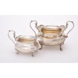 A silver oblong baluster cream jug and sugar basin by Walker & Hall