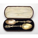 A cased pair of matched continental silver spoons