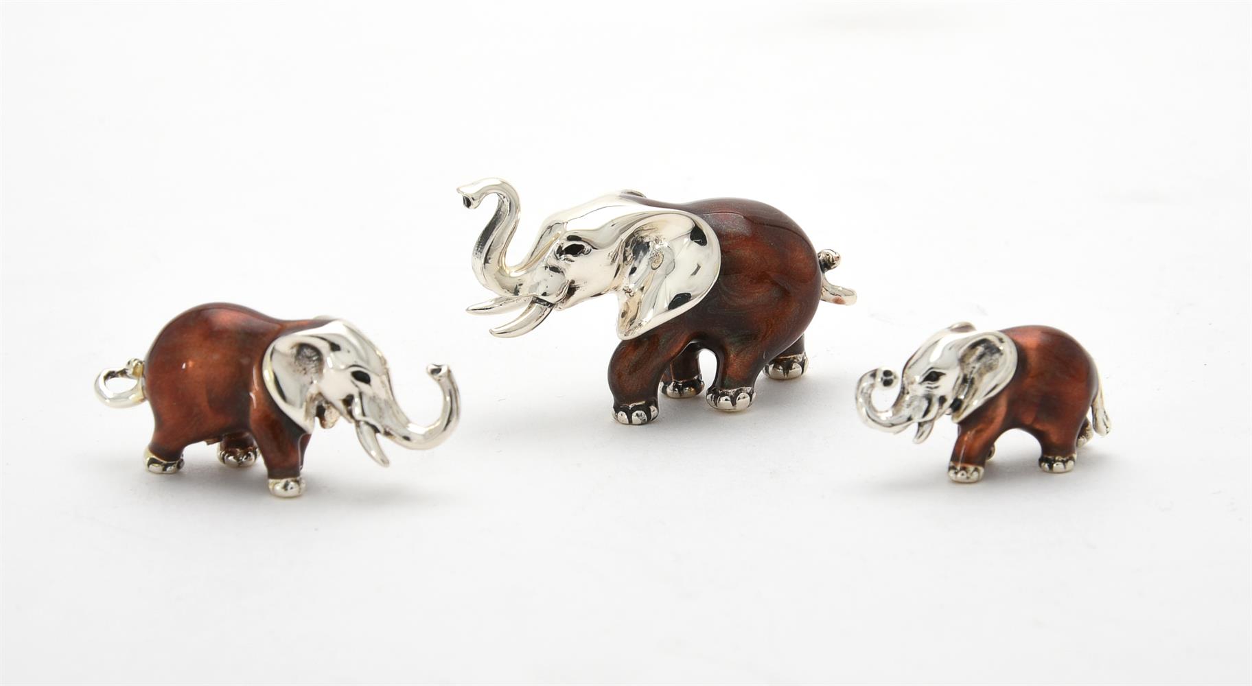 Three silver and enamel elephants