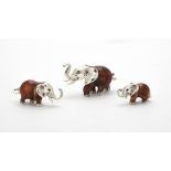 Three silver and enamel elephants