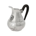 An Italian silver coloured pear shaped cream jug