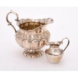 A continental silver coloured lobed cream jug