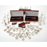 A collection of silver stringed musical instrument pendant boxes and stands