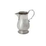 An American silver coloured baluster cream jug by Cartier