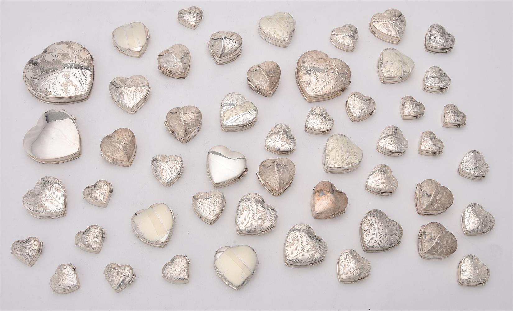 A collection of silver heart shaped boxes