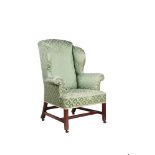 A George III mahogany and upholstered wing armchair