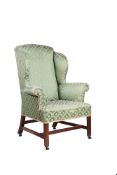 A George III mahogany and upholstered wing armchair