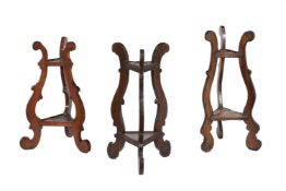 A harlequin group of three beech and walnut triangular two tier stands