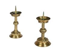 A pair of German or Dutch repousse brass pricket candlesticks