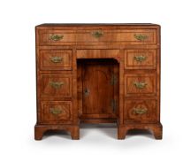 A George II walnut and feather banded kneehole desk