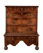 A walnut and featherbanded chest on stand