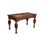 A Victorian carved oak writing table