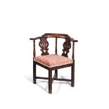 A George III mahogany and upholstered corner armchair