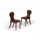 A pair of Regency mahogany hall chairs