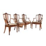 A set of four oak and upholstered armchairs in George III style